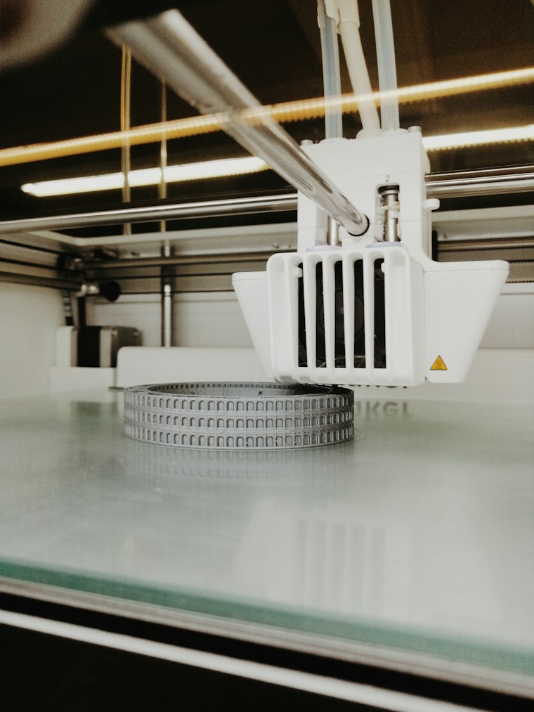 FDM printer printing a white prototype part